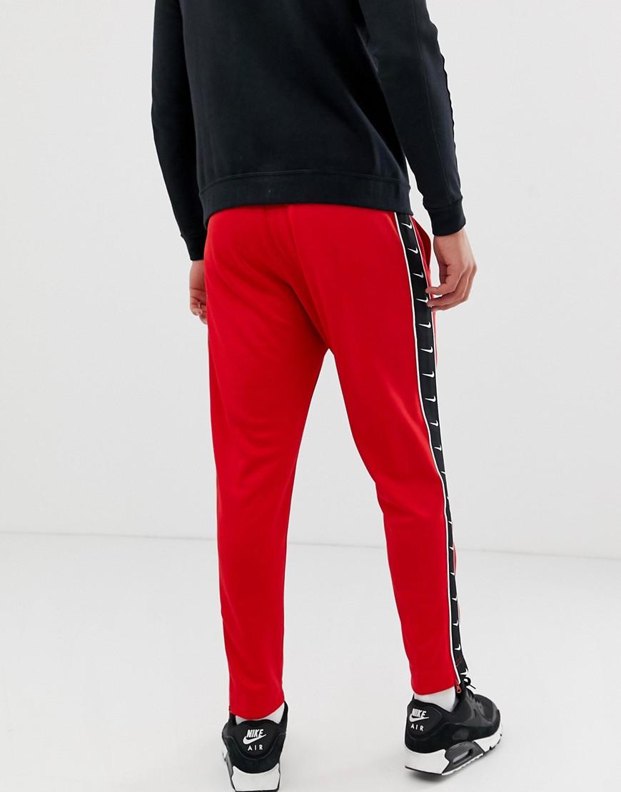 nike swoosh poly knit pants red