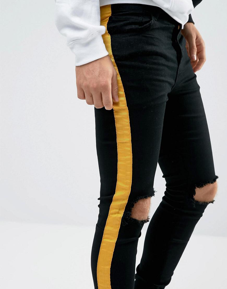 black jeans with yellow stripe