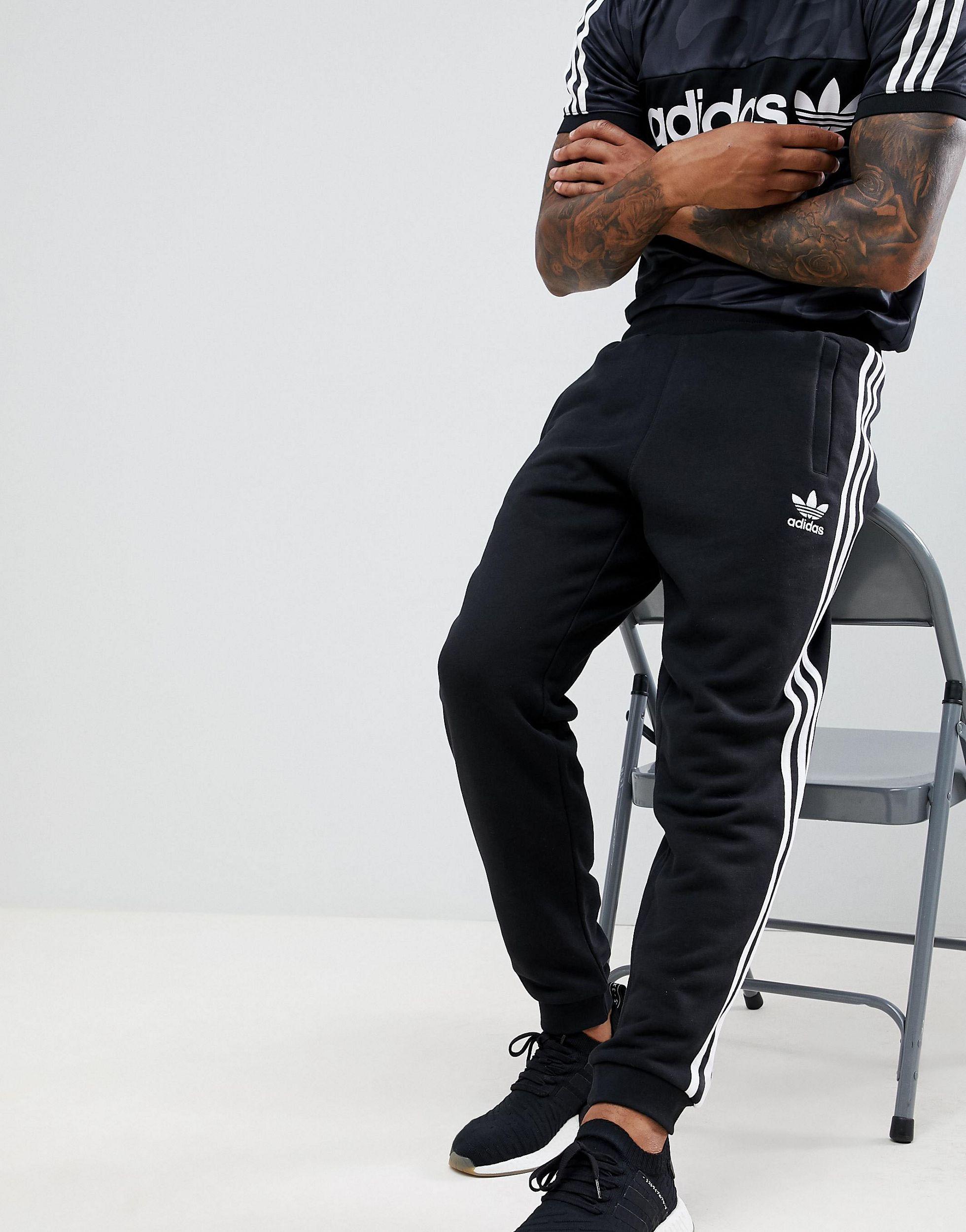 black adidas joggers with black stripes