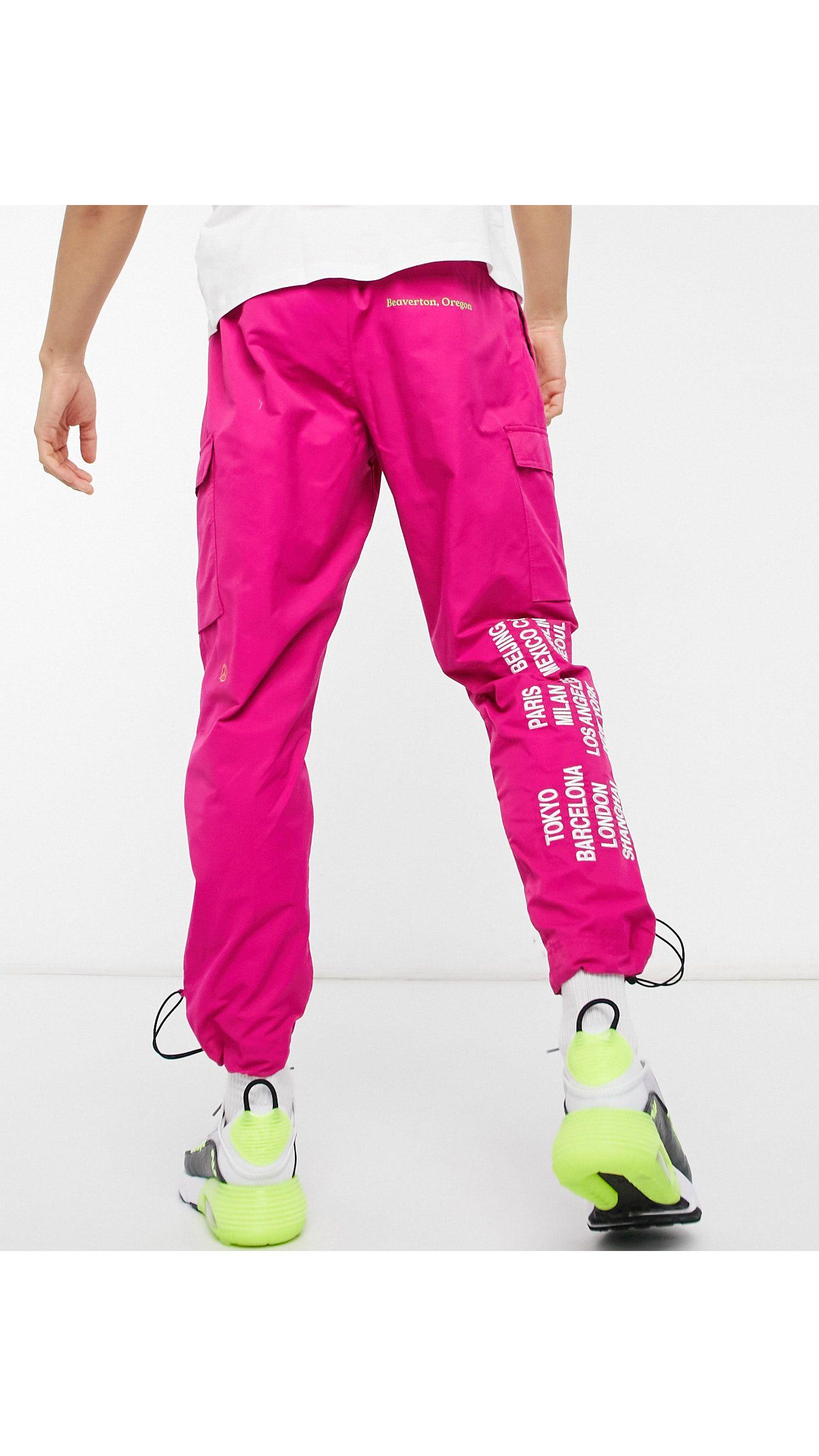 Nike World Tour Pack Graphic Woven Cuffed Cargo Trackies in Pink for Men |  Lyst Australia