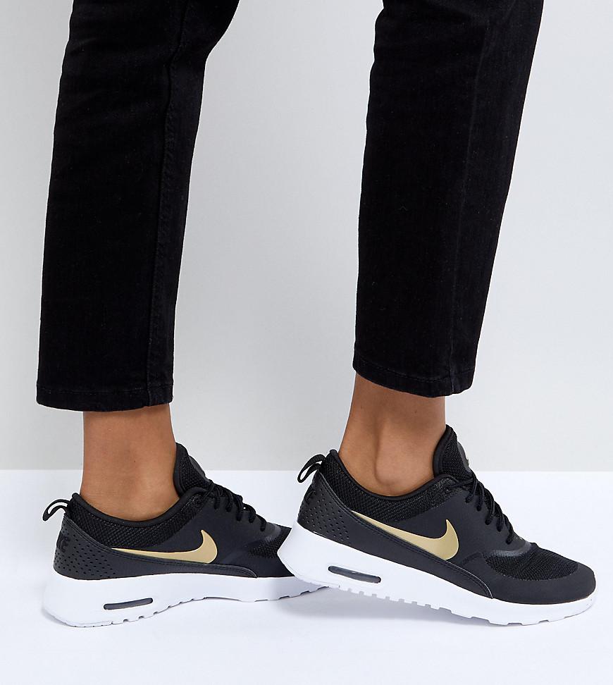 nike air max thea trainers in white and gold