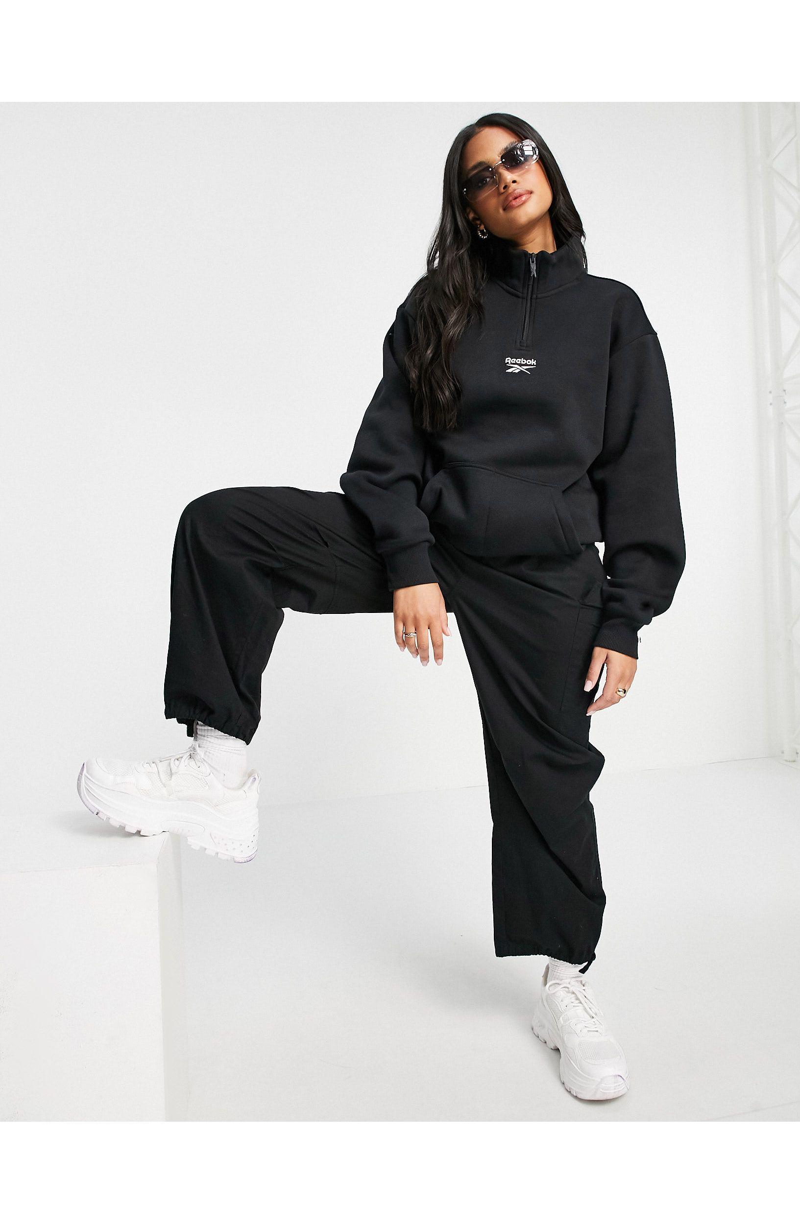 Sudadera negra con logo, cremallera corta y cordón en el bajo Reebok de  Algodón de color Negro - Lyst