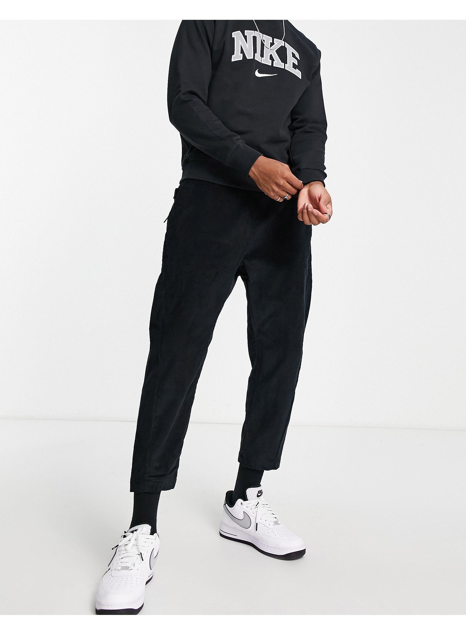 Nike Corduroy tapered cropped trousers in black | ASOS