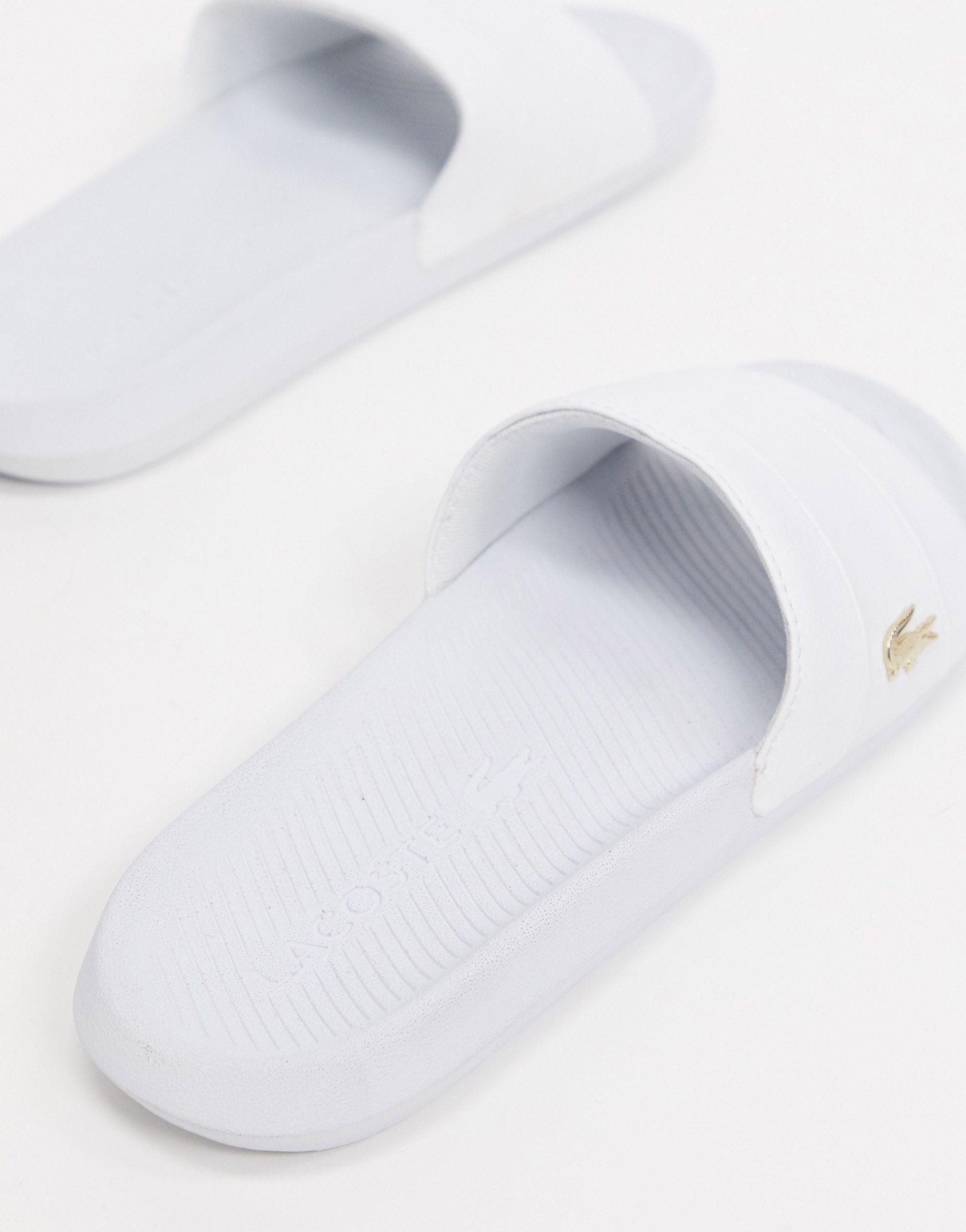 white and gold lacoste slides