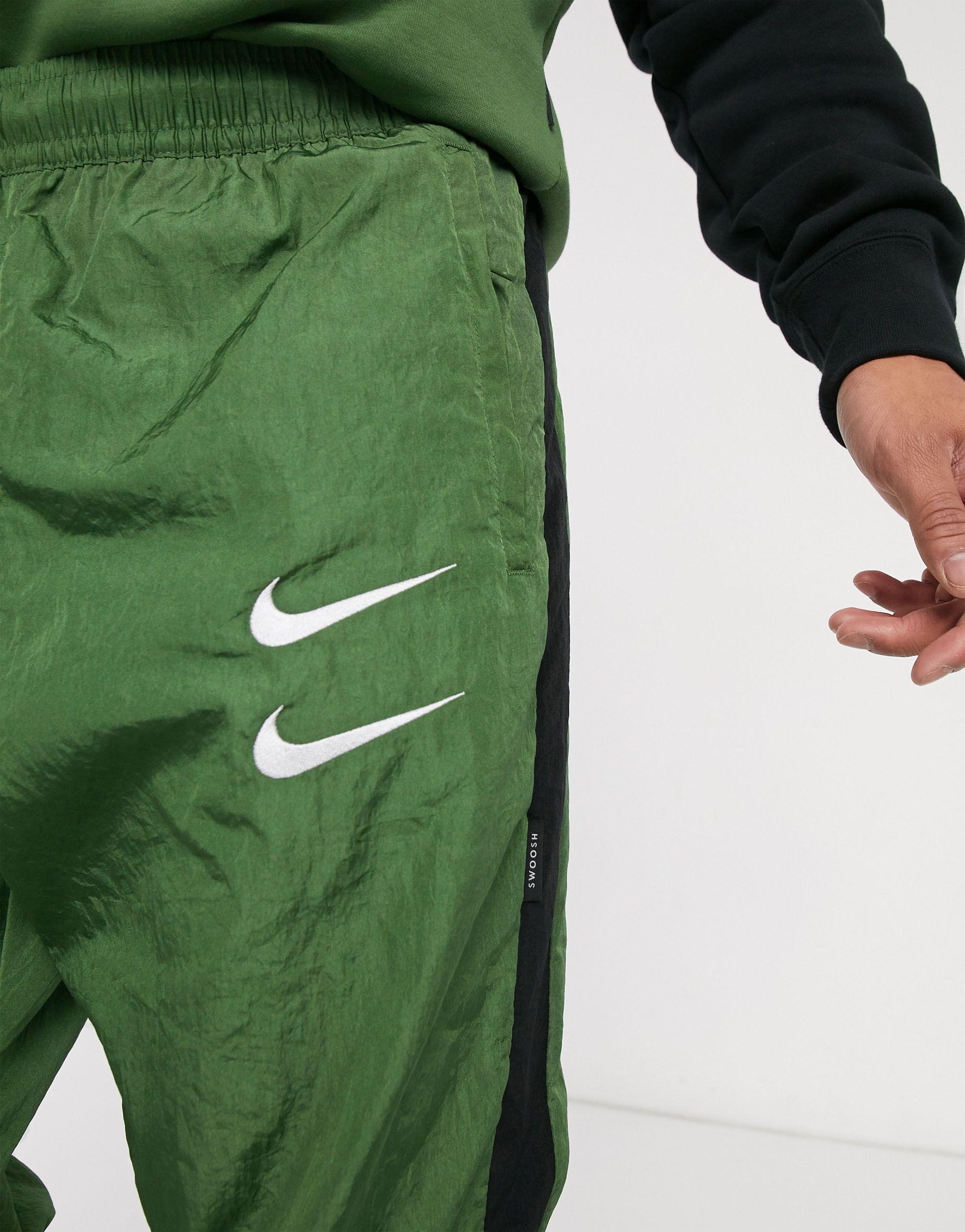 nike swoosh pants green