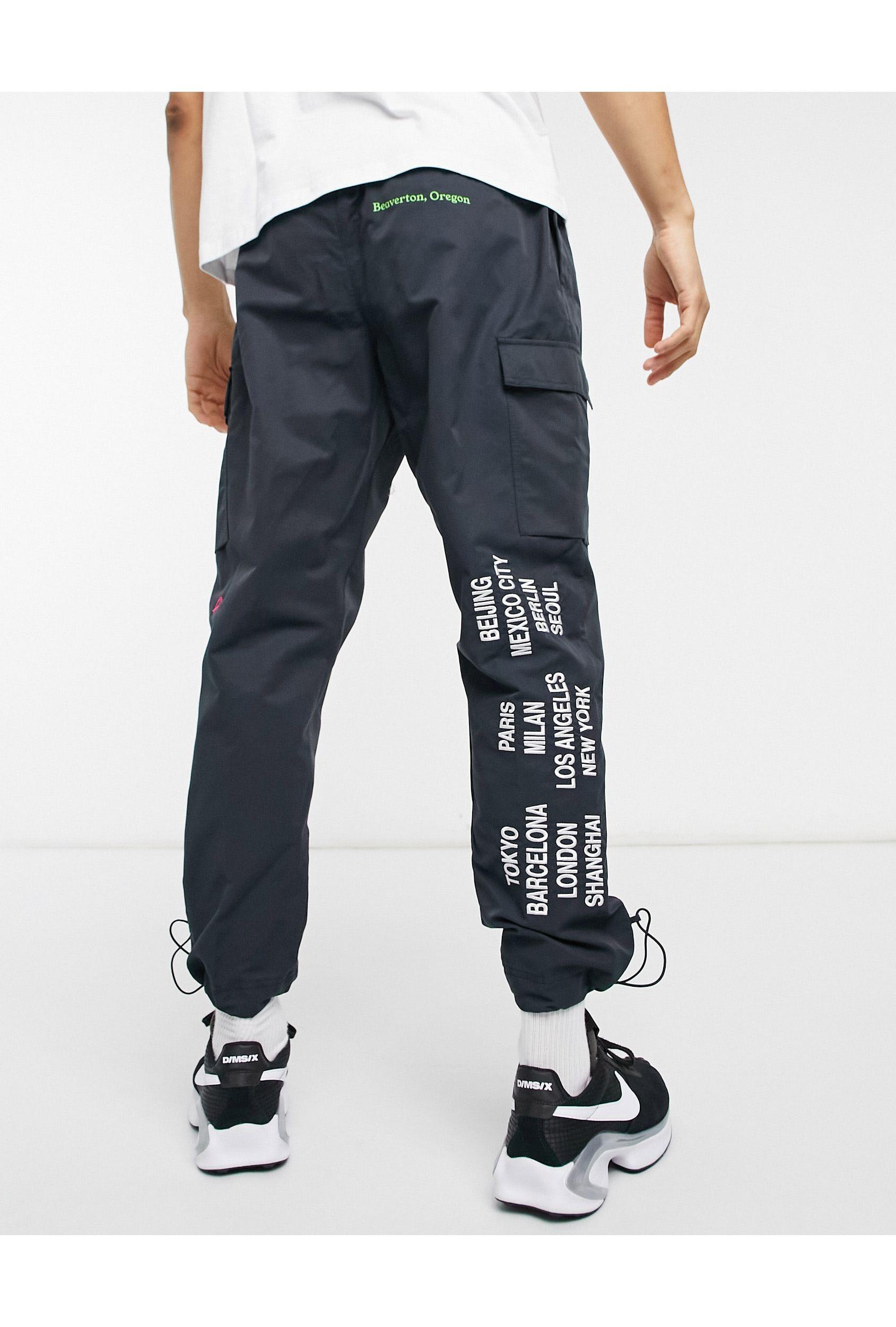 Nike world tour pack graphic woven cuffed cargo joggers in black Clearance