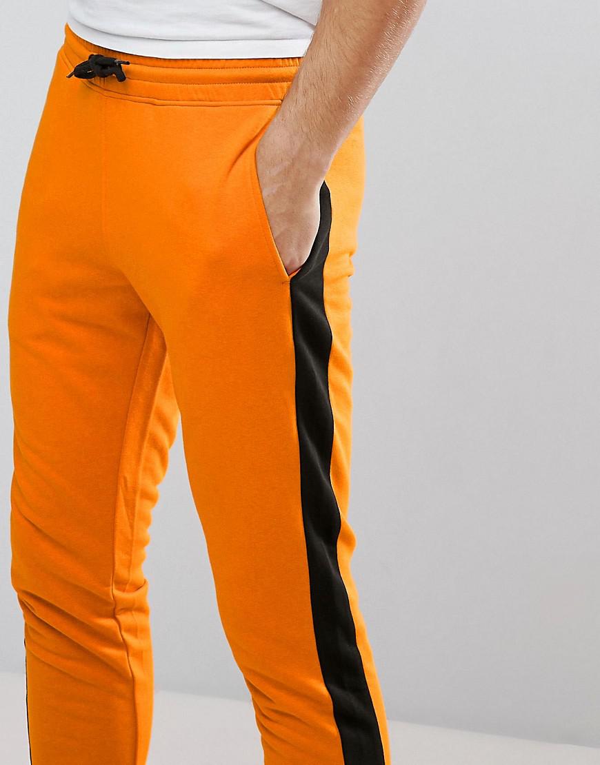 orange and black track pants