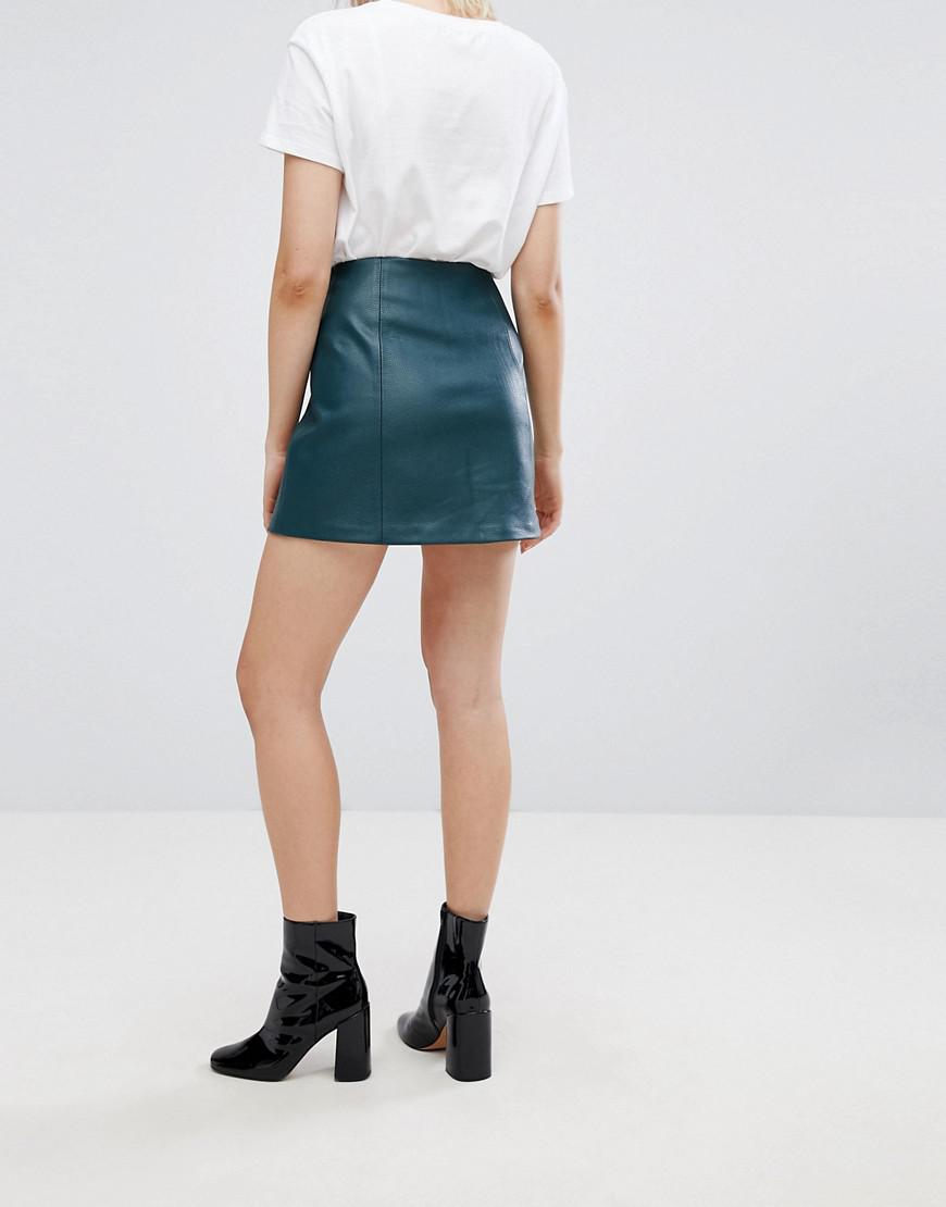 green mini skirt zip