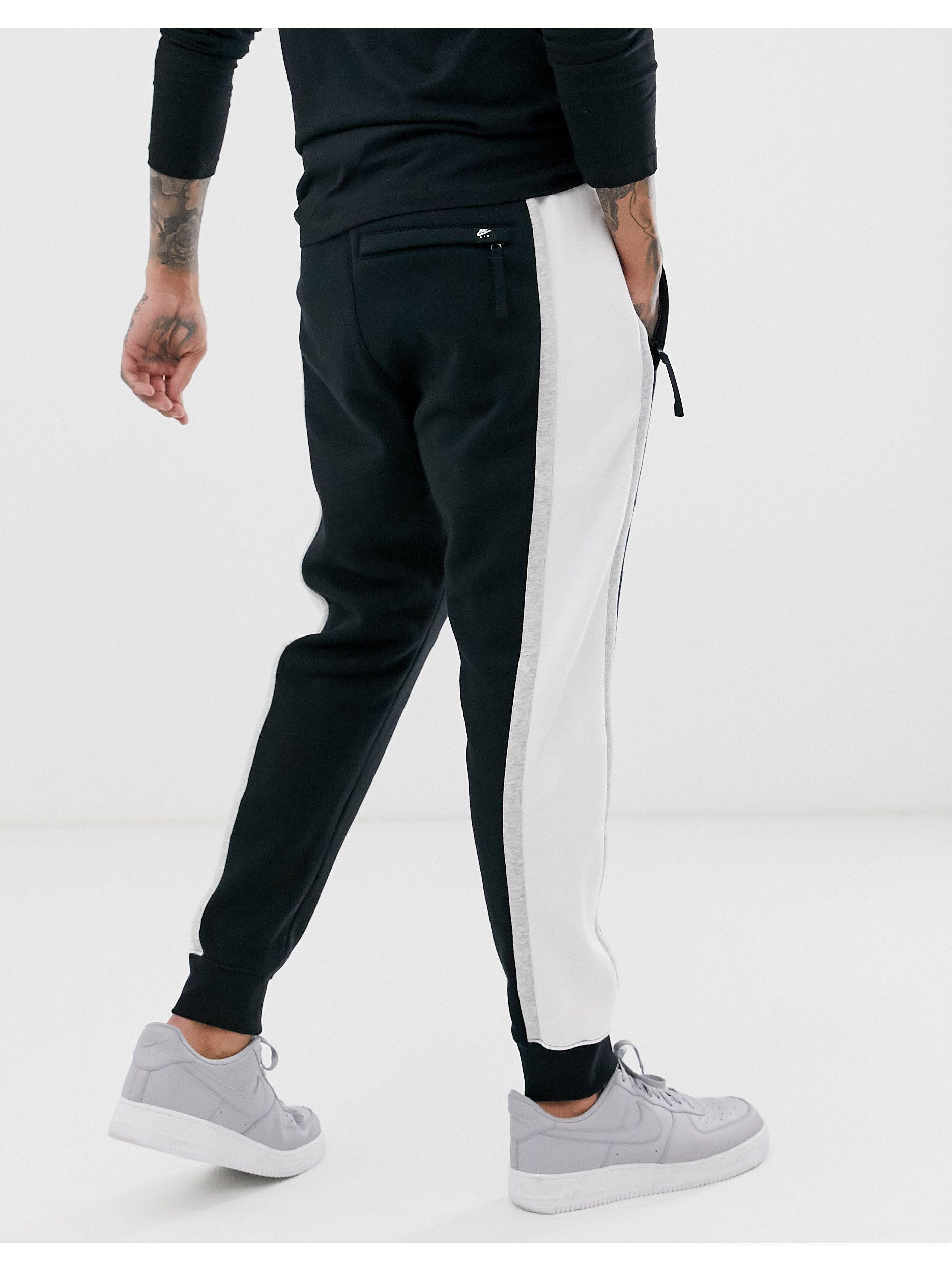 nike black sweatpants with white stripe