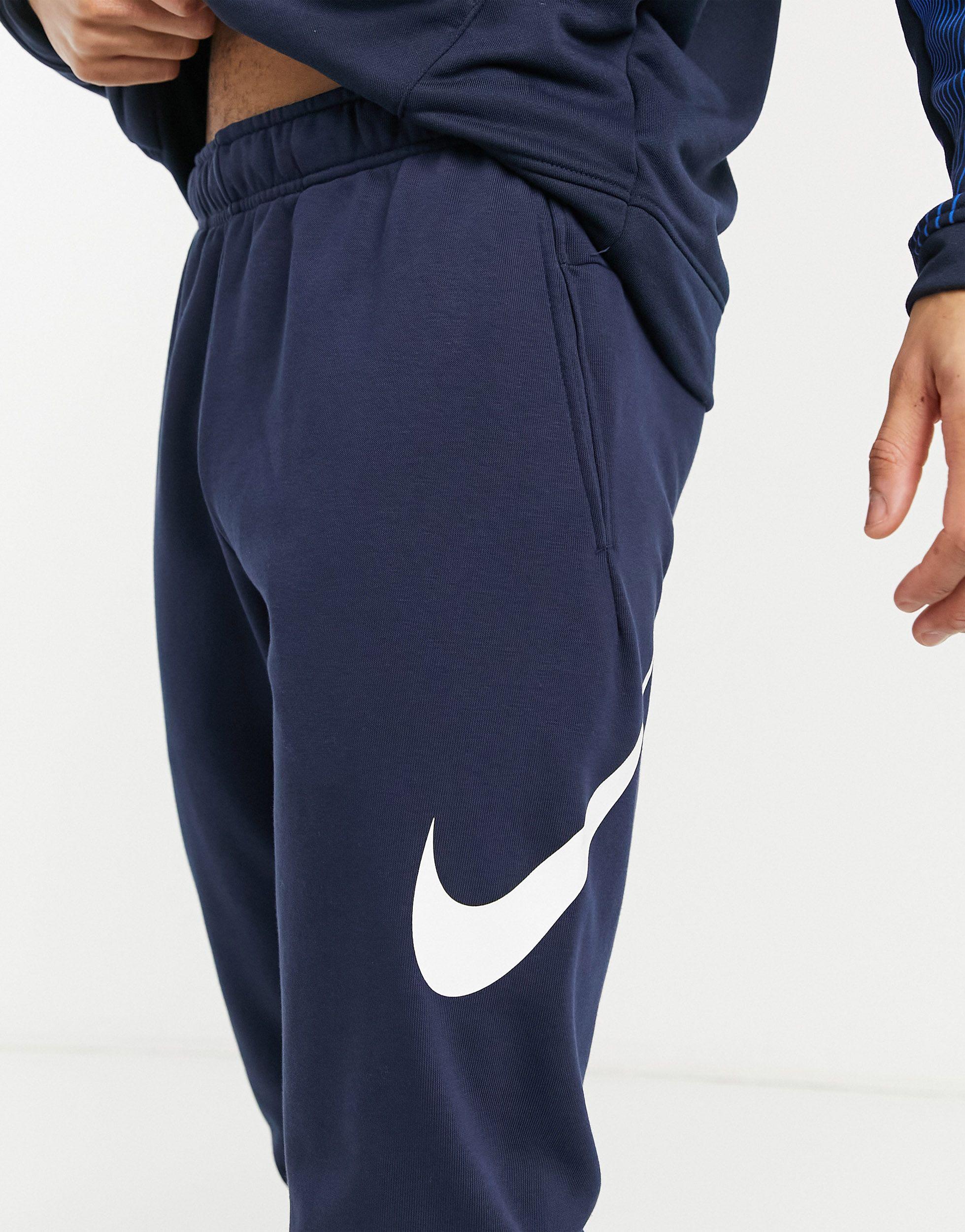 blue nike swoosh joggers