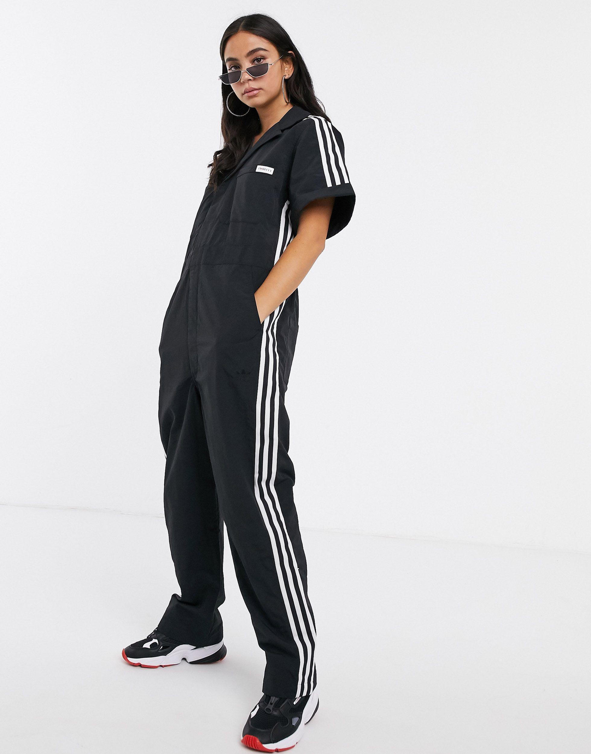 X Fiorucci - Tuta lunga nera con tre strisceadidas Originals in Materiale  sintetico di colore Nero | Lyst