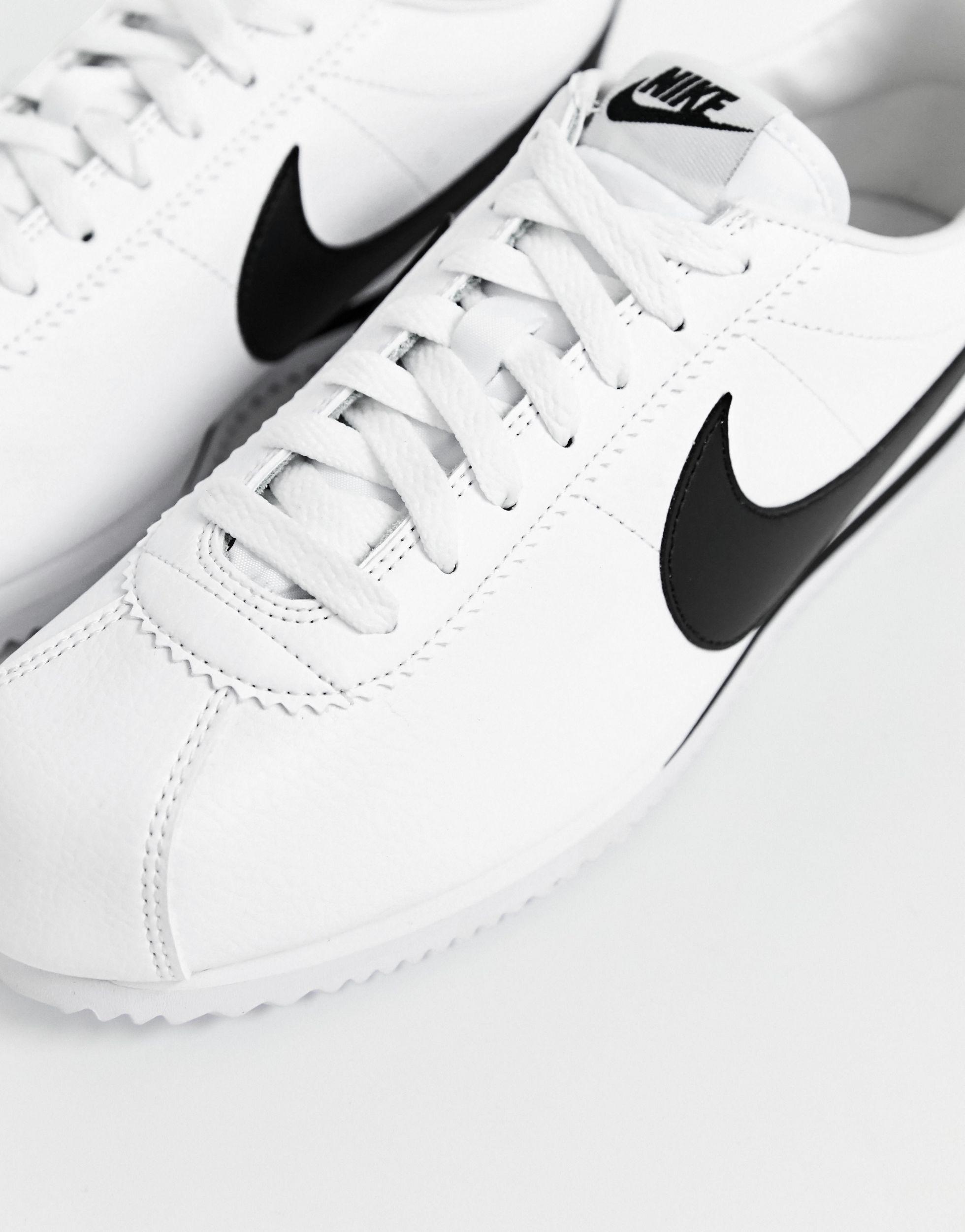 nike cortez leather trainers in white with black swoosh