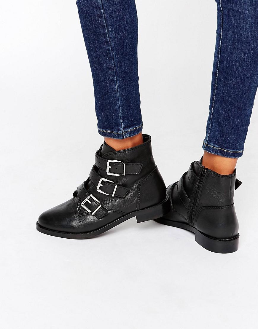 black flat buckle boots