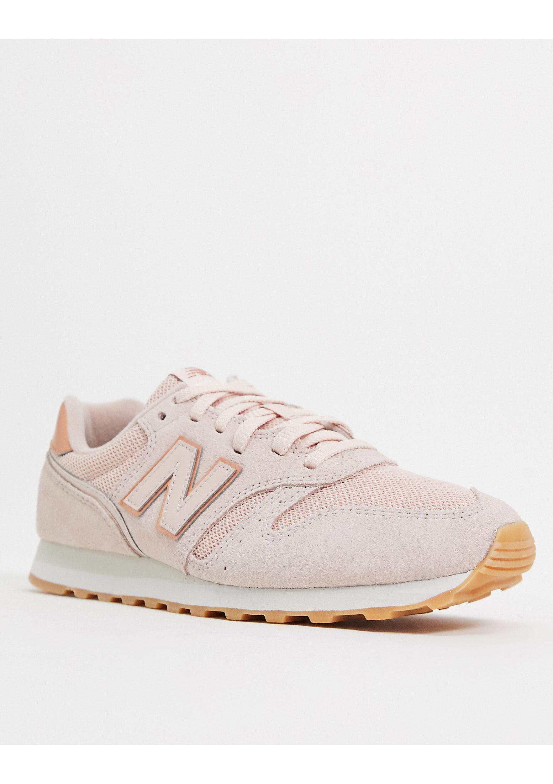 new balance 373 sneakers in black and rose gold