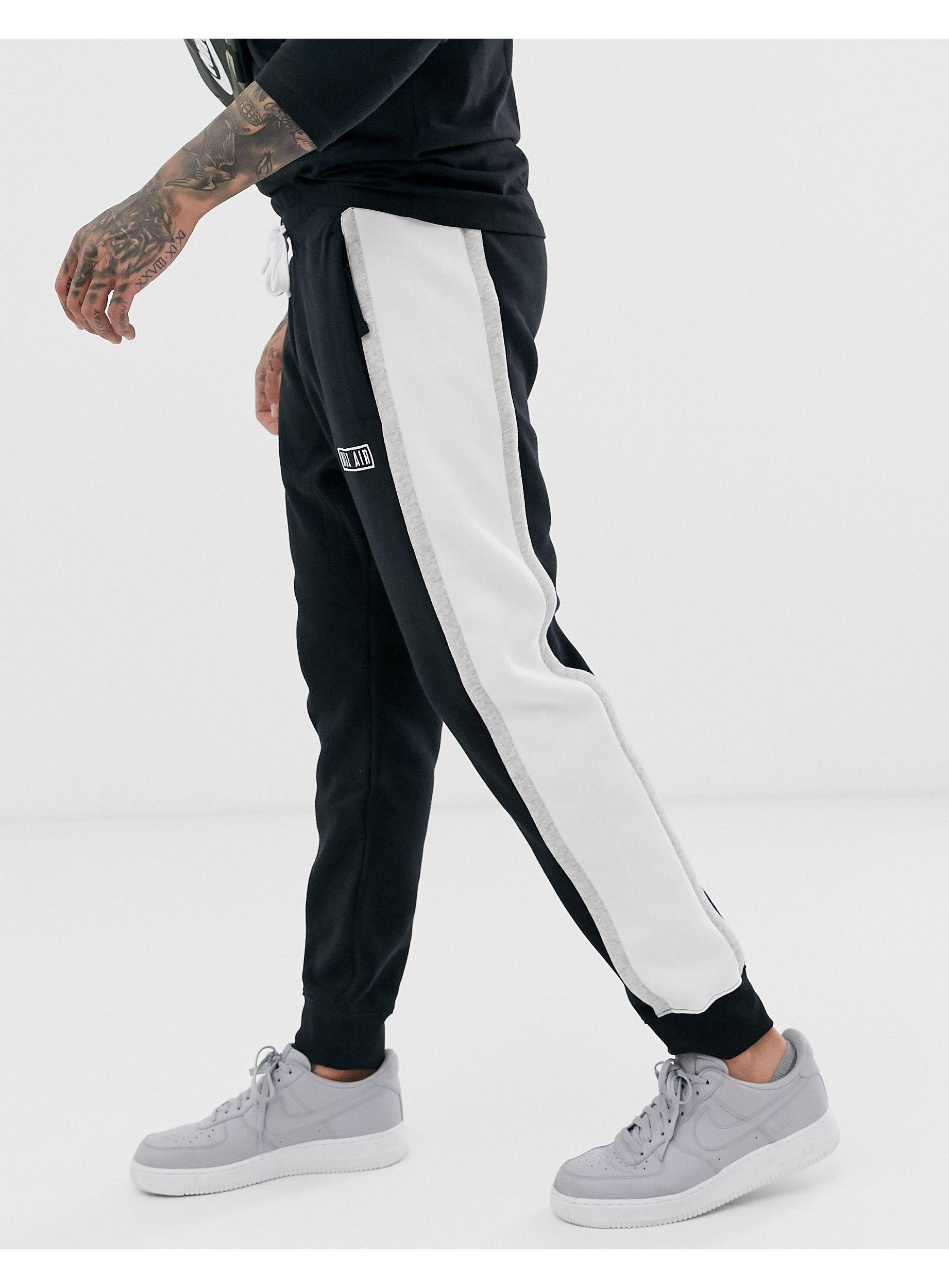 nike black sweatpants with white stripe