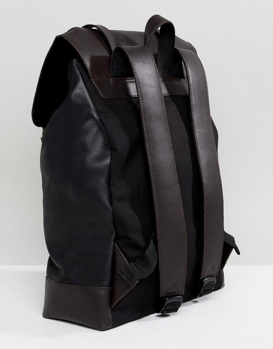 black backpack with brown straps