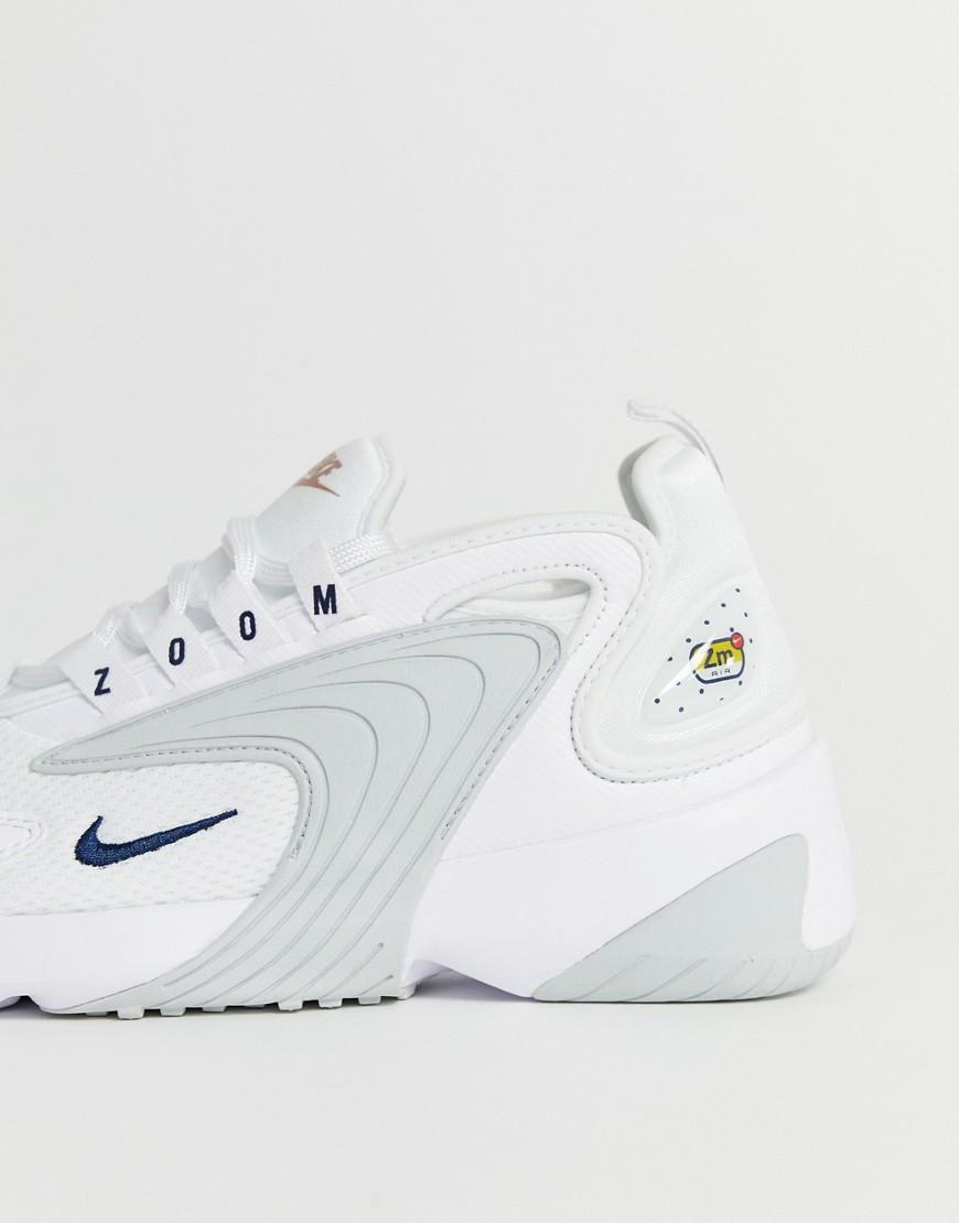 white and rose gold nike trainers