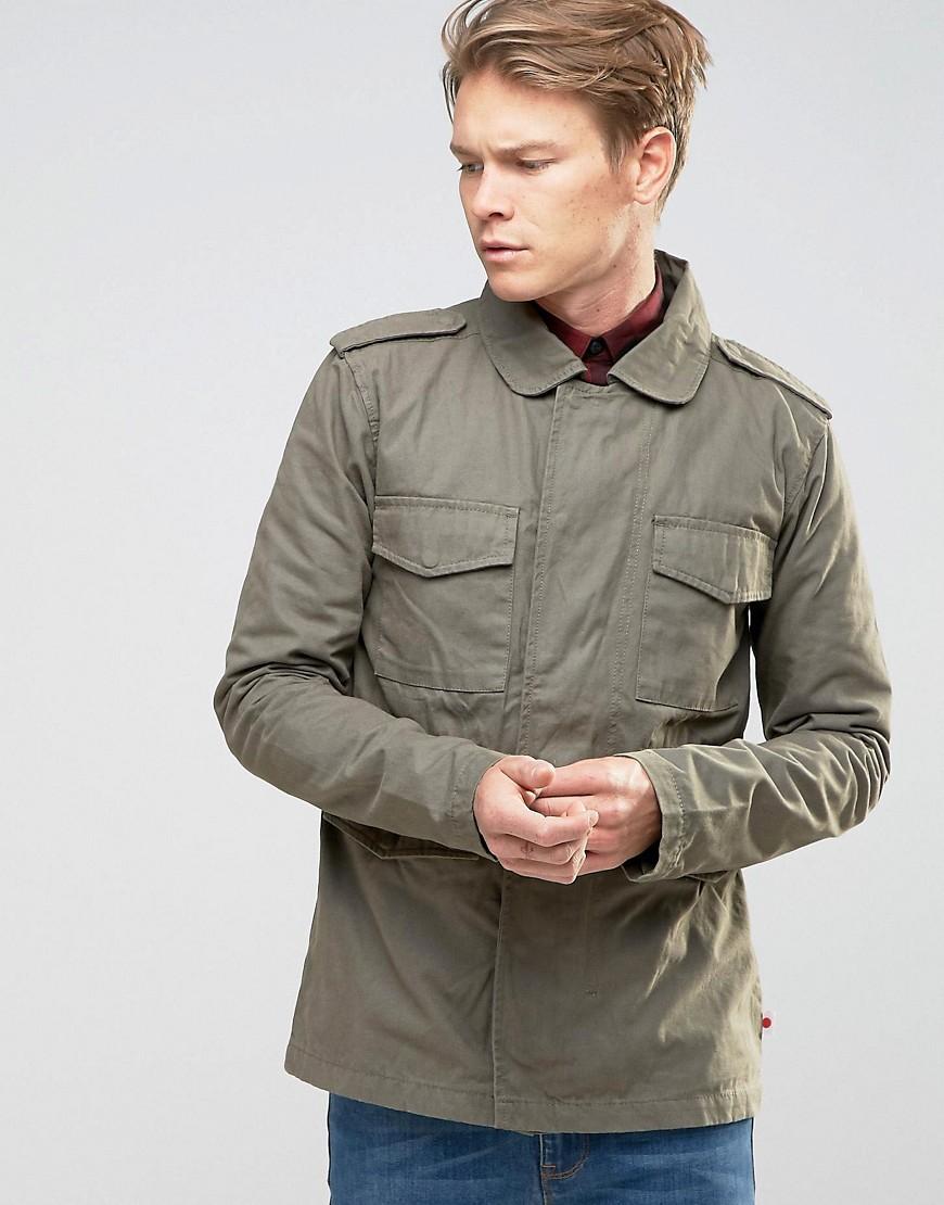Shop by category Try wearing a military jacket buttoned up with a decorative belt around the outside. With a Dress 7 of 11 Pair your olive military jacket with a dress in fall colors.