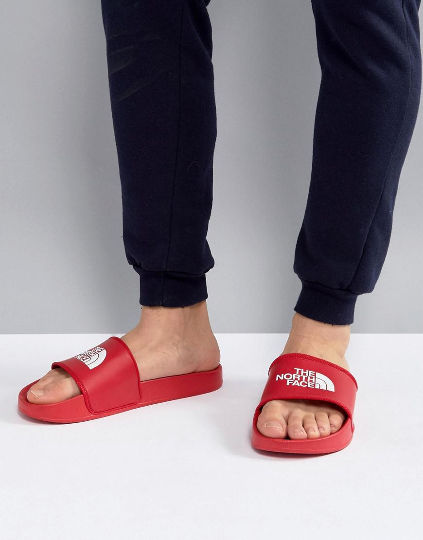red north face sliders