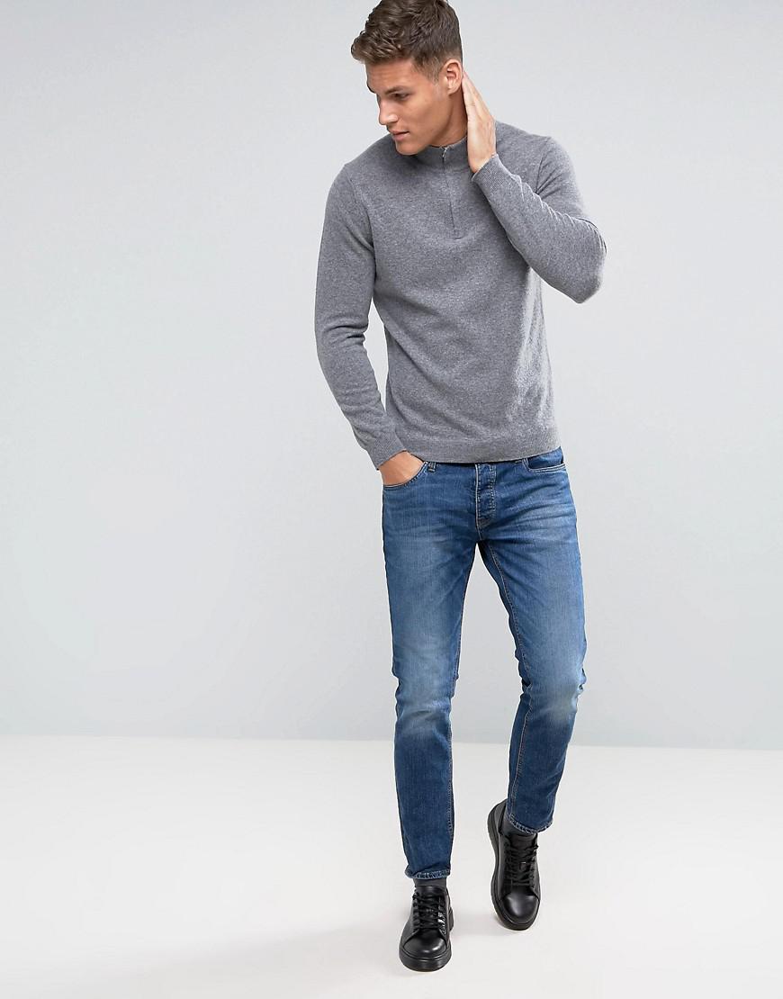 grey jumper and blue jeans