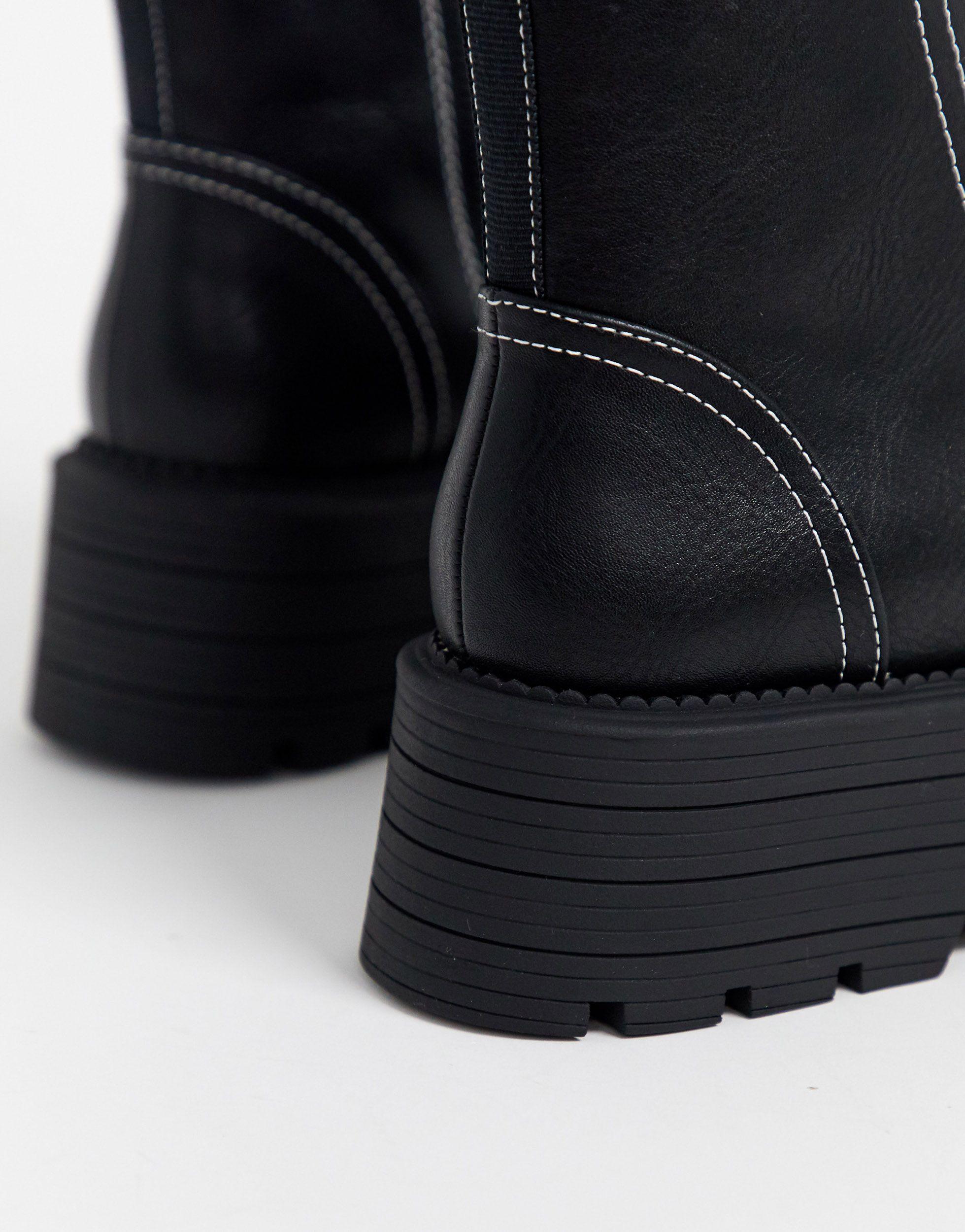 black boots white stitching