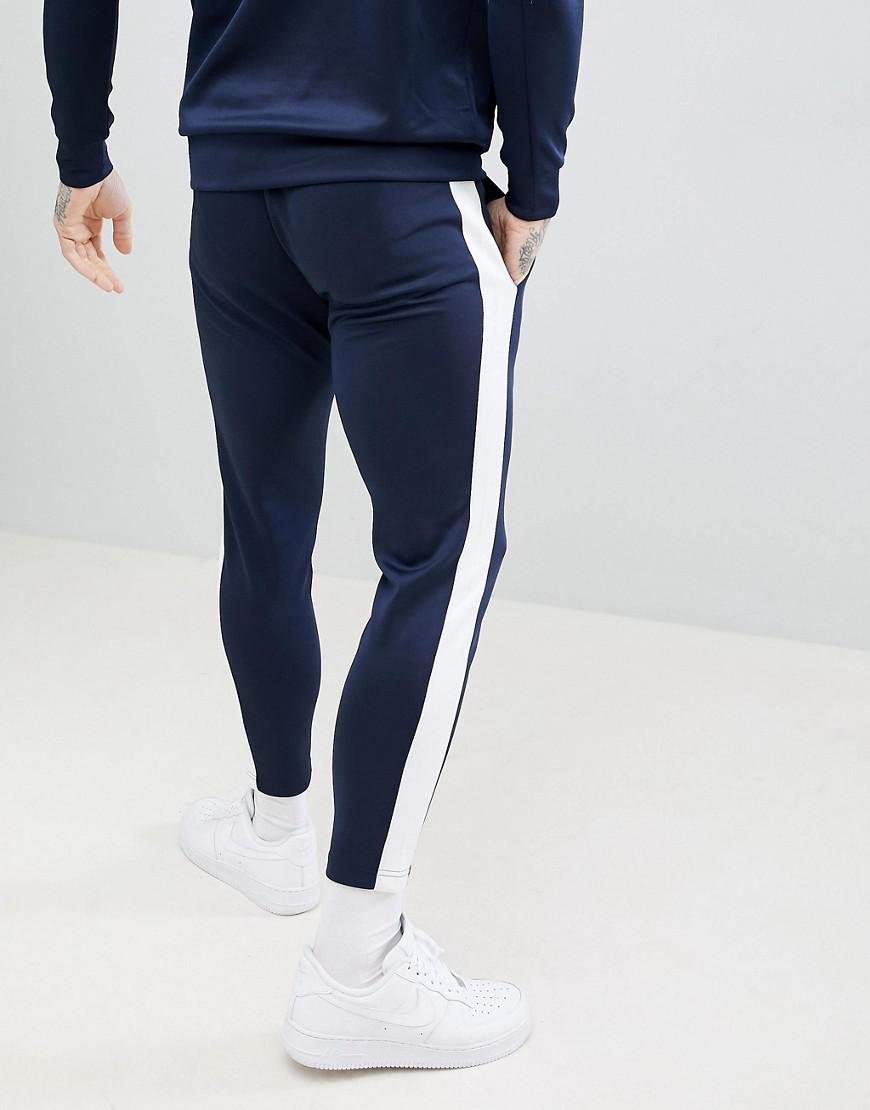 blue joggers with white stripe