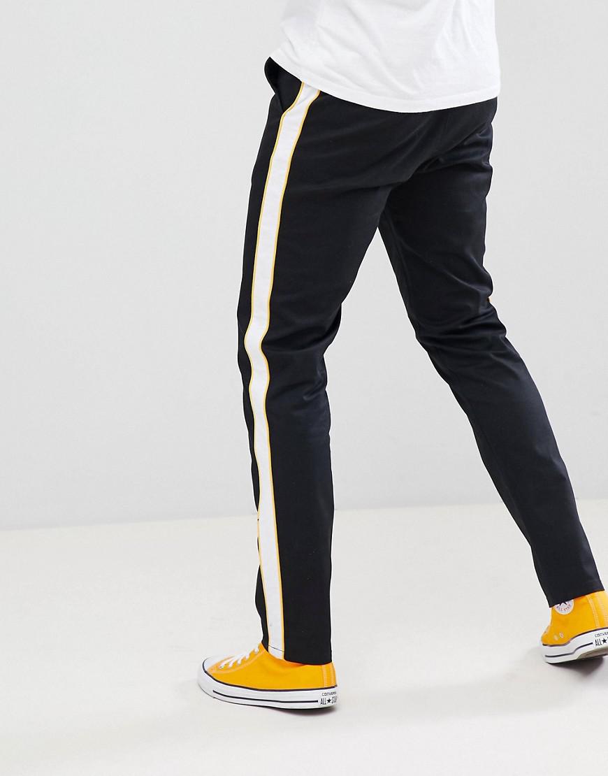 black pants with yellow side stripe