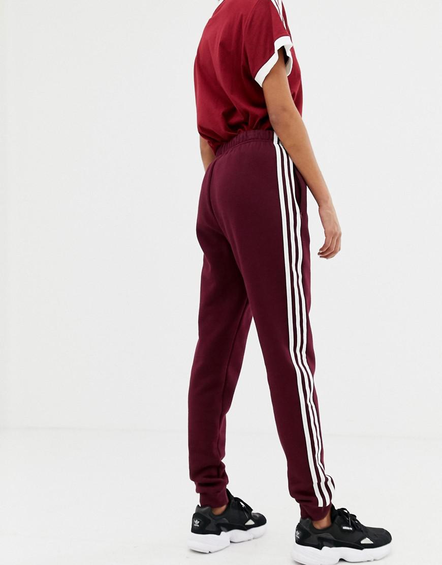adidas originals adicolor three stripe track pants in red