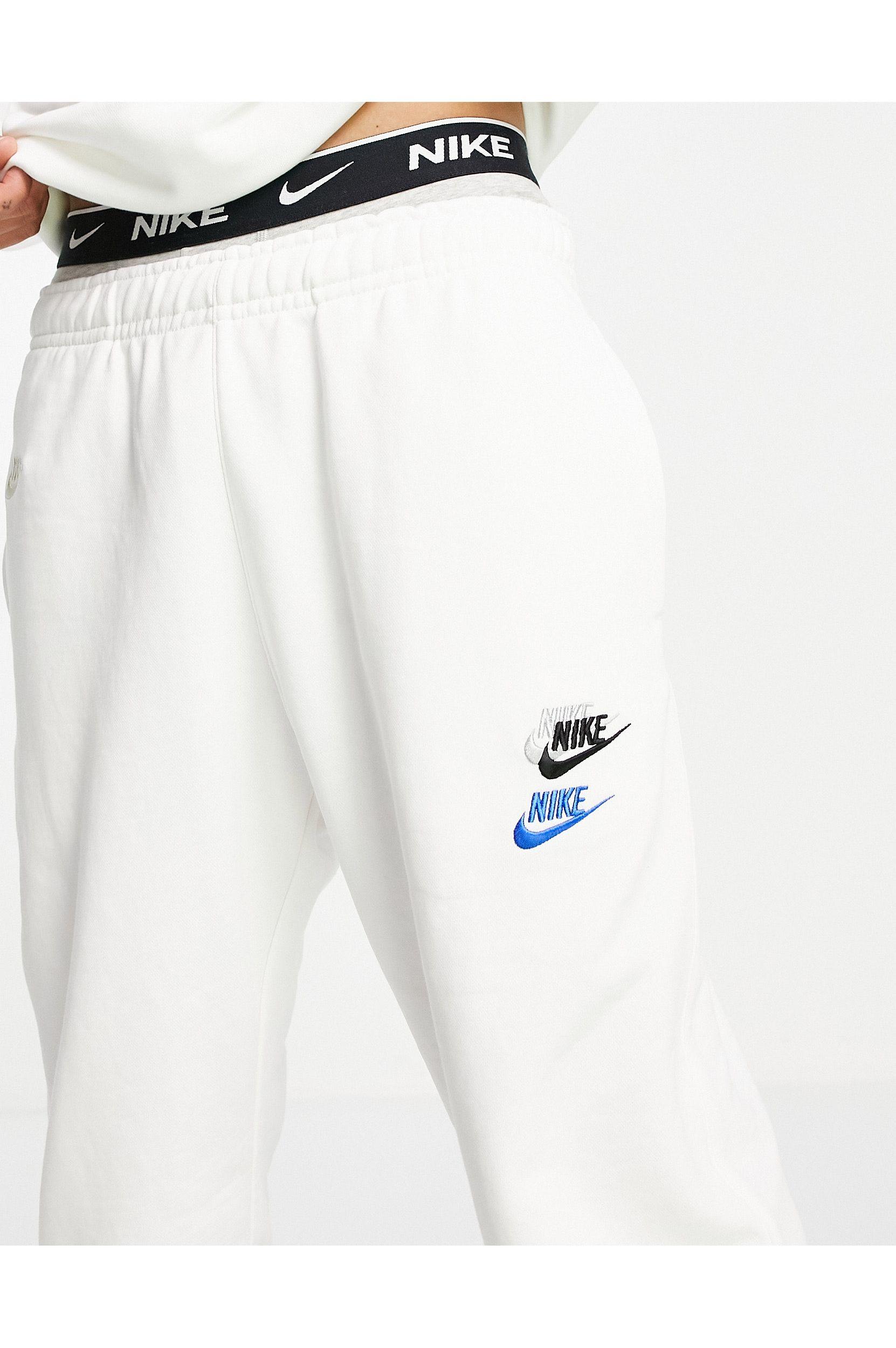 Nike Essential Fleece+ Multi Logo Casual Fit Cuffed Trackies in White for  Men | Lyst Australia