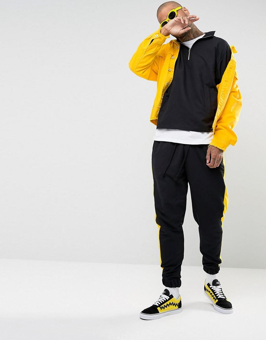 yellow joggers black stripe