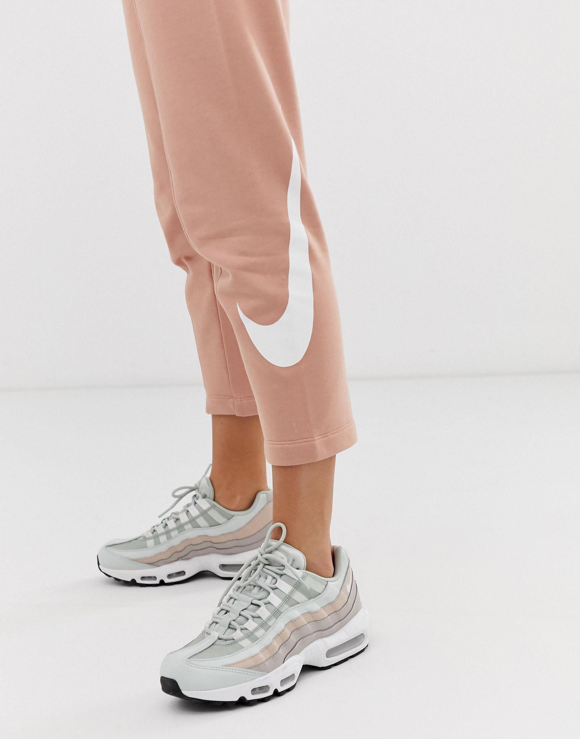 nike rose gold oversized swoosh joggers