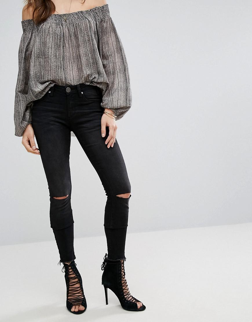 jeans with one ripped knee