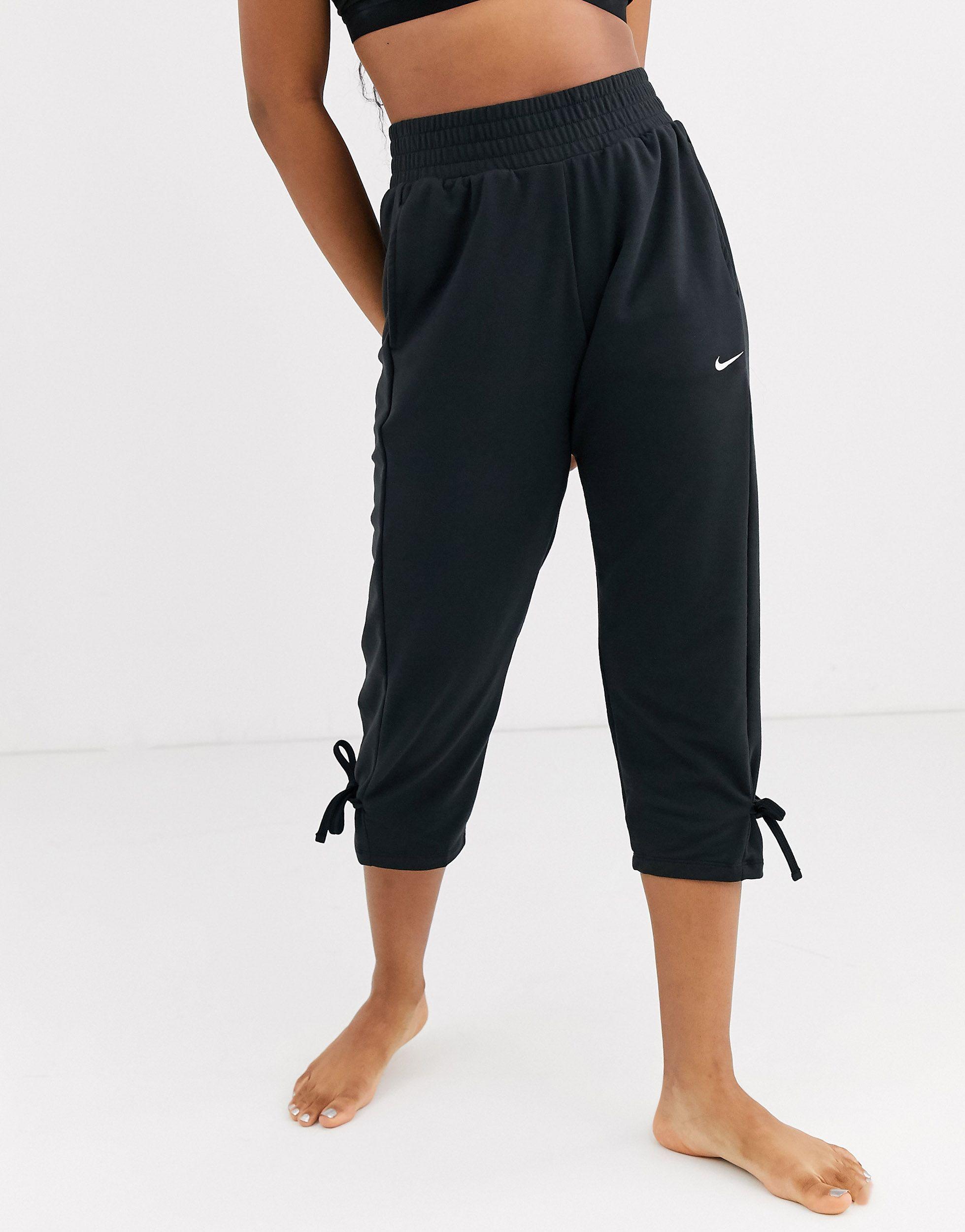 Nike Synthetic Nike Yoga Loose Fit Pants With Tie Detail, Plain Pattern in  Black - Lyst