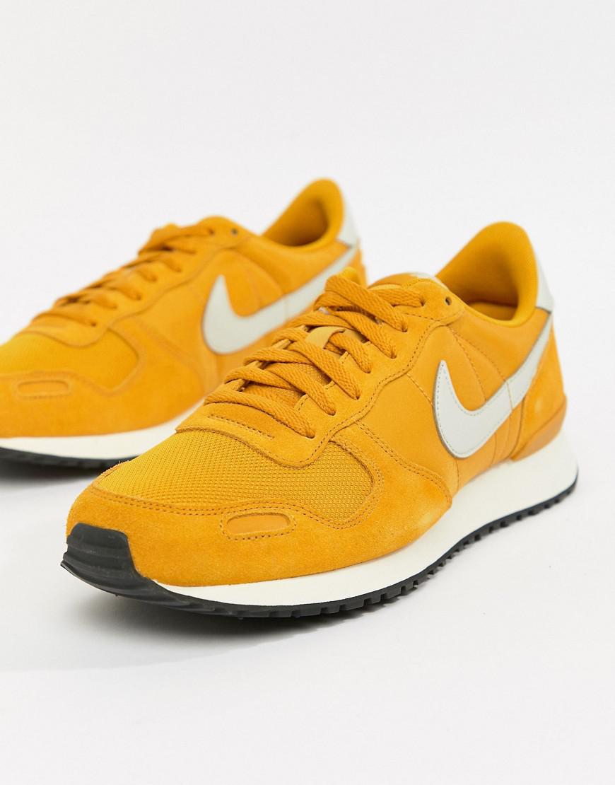 white and yellow nike trainers