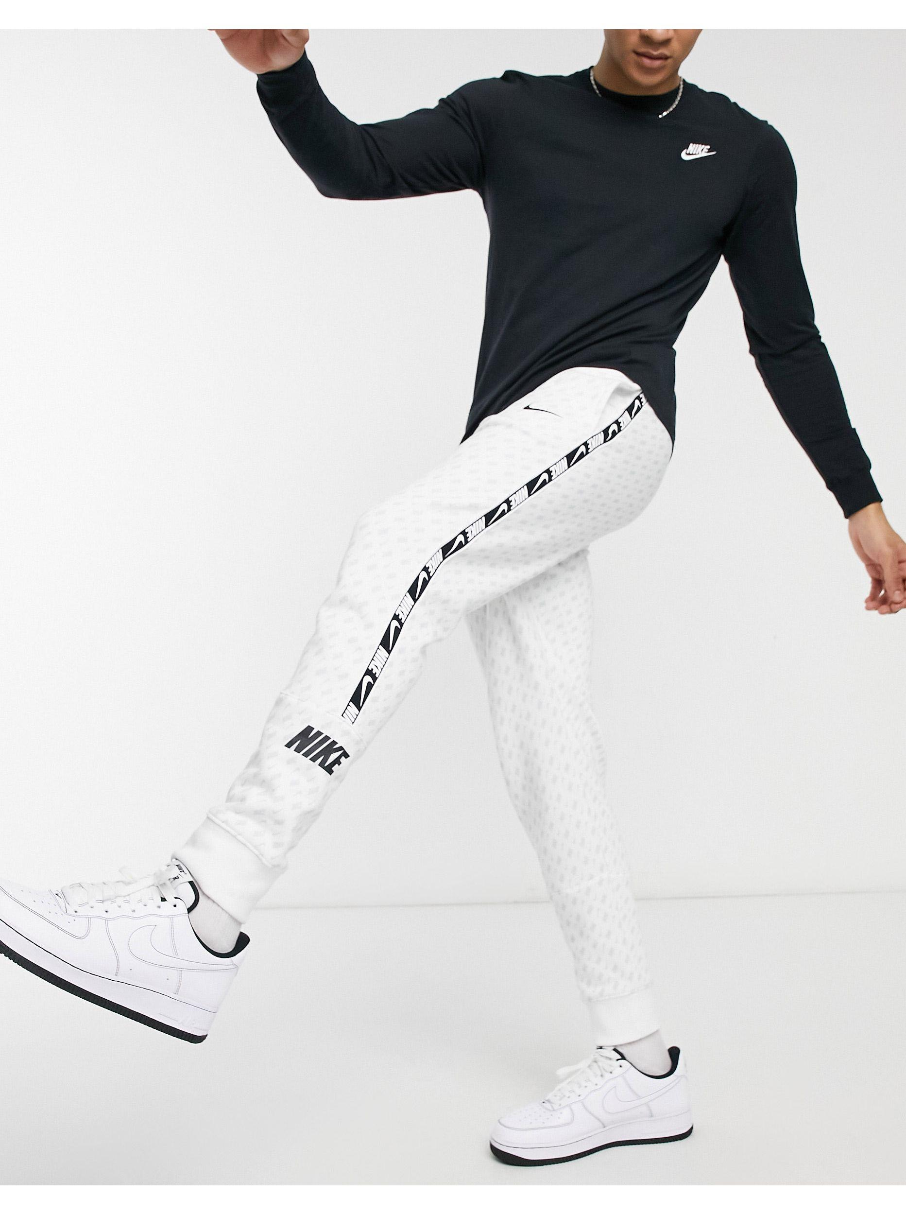 Nike Repeat Pack All over Logo Print Taping Cuffed Track Pants in White for Men Lyst UK