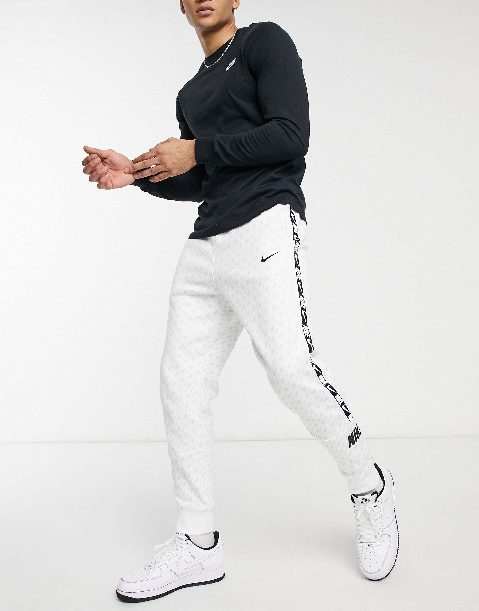 Nike Repeat Pack All-over Logo Print Taping Cuffed Track Pants in White for  Men | Lyst UK