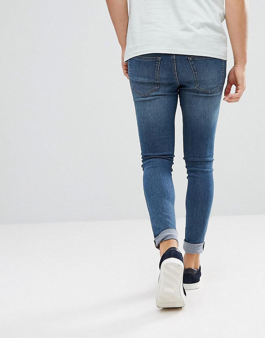 blue spray on skinny jeans