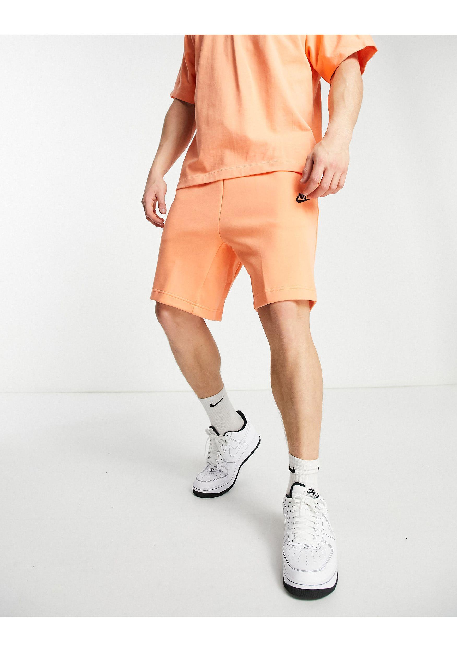 orange nike tech fleece pants
