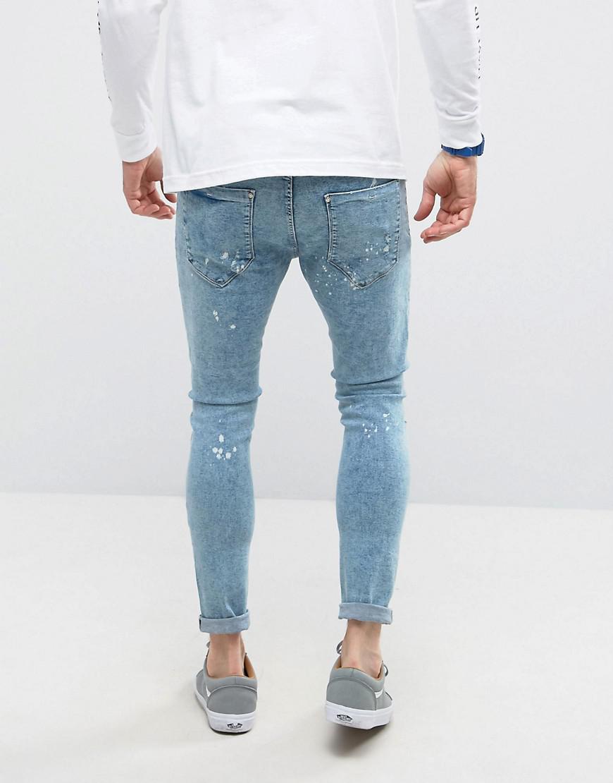 Lyst - Bershka Super Skinny Jeans With Knee Rips In Bleached Blue in ...