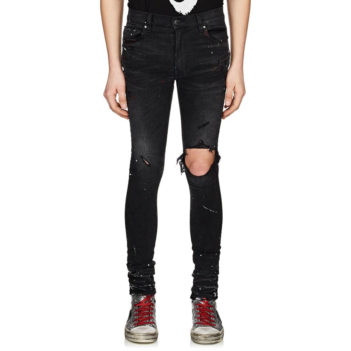 black amiri jeans with paint