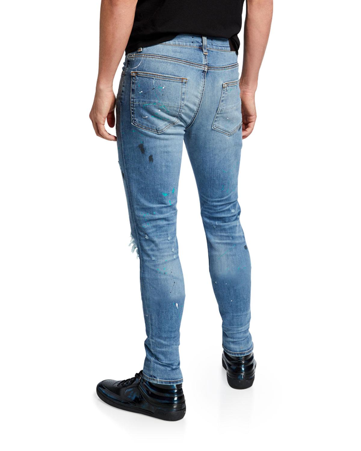 Amiri Denim Men's Paintsplatter Skinny Jeans With Ripped Knee in Blue