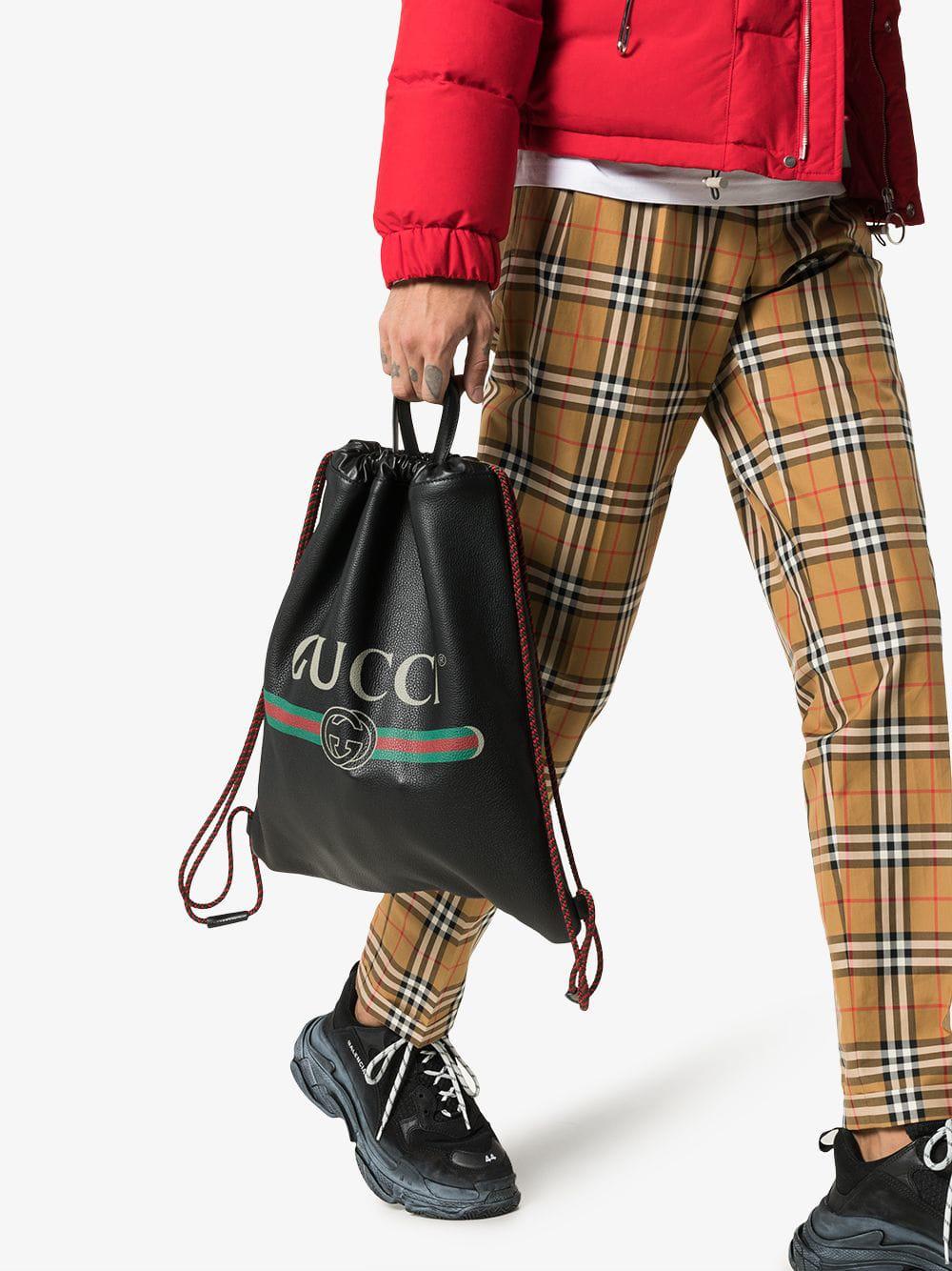 Gucci Logo Printed Leather Drawstring Backpack in Black for Men | Lyst