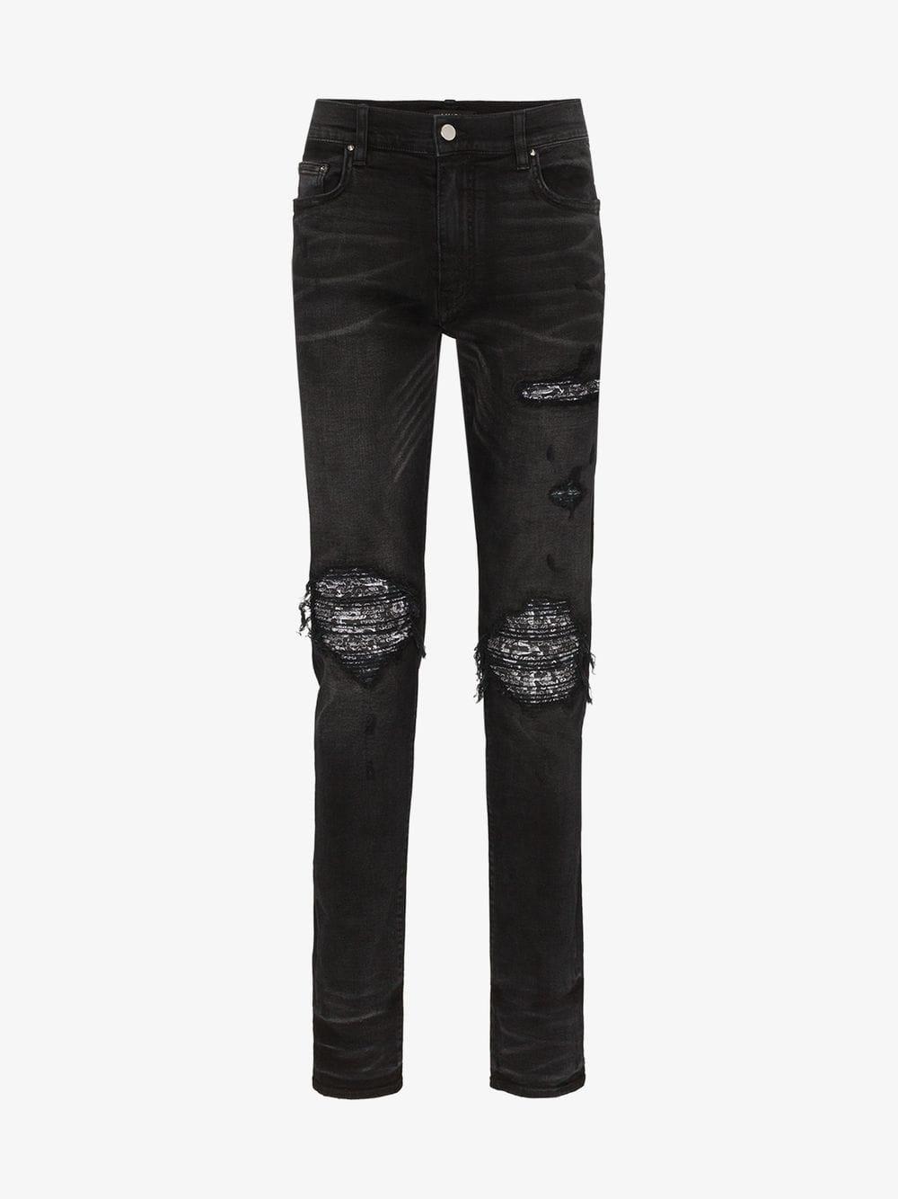 black amiri jeans with patches