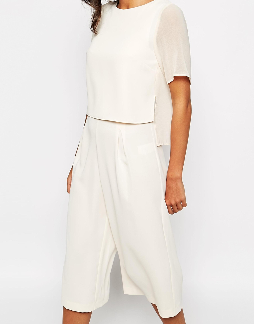 cream jumpsuit with cape
