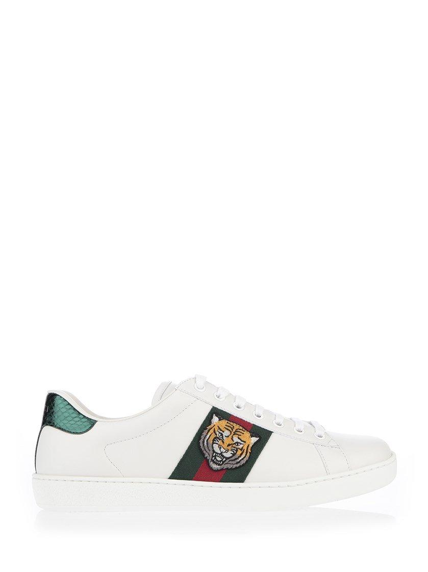 MILAN - JUNE 19: Man with white leather Gucci sneakers with tiger