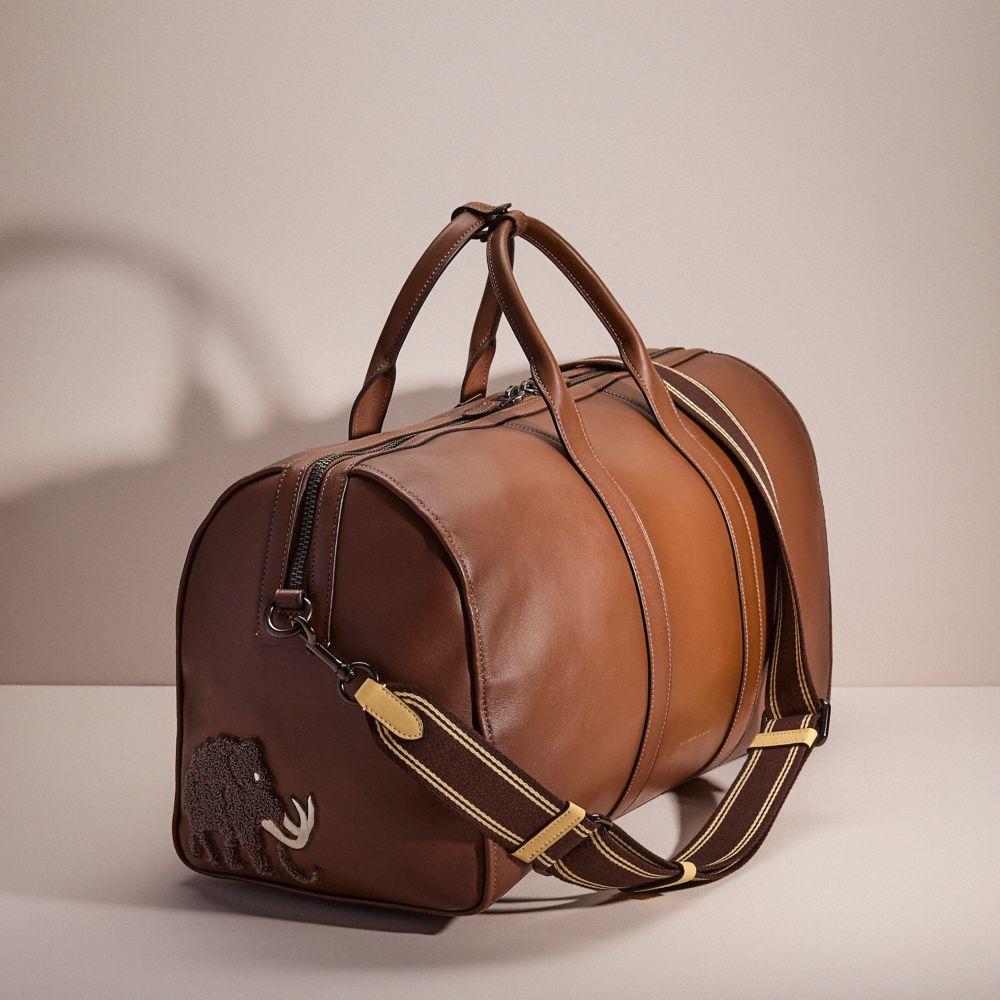 coach travel men duffel bag Soccer Duffle Brown / Ivory Crafted of Signature canvas and smooth leather this duffle bag includes inside snap cell phone and multifunction pockets for easy organization and it comfortable fits a tablet COACH Men's Gotham 45 in