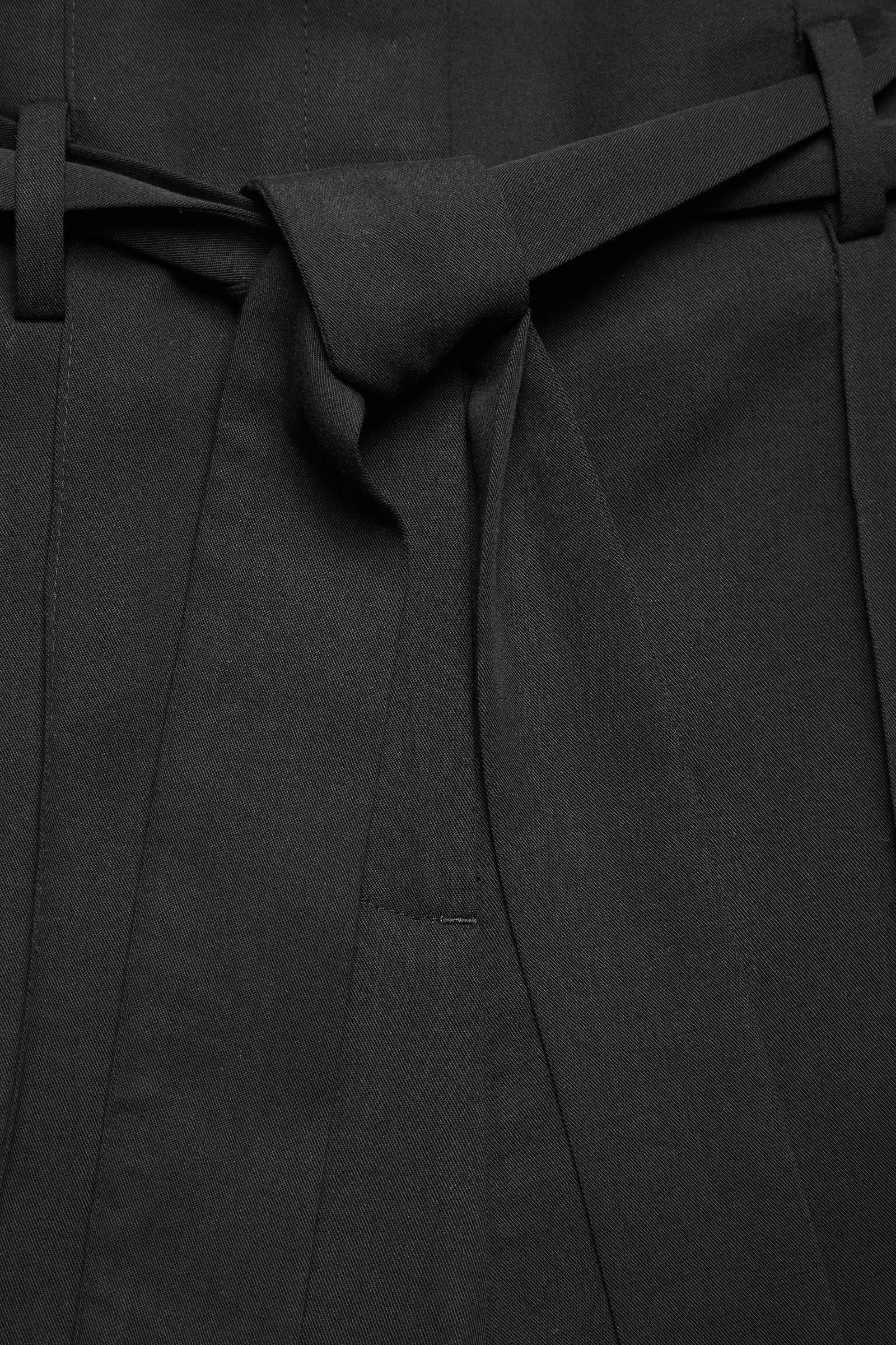 high waisted black belted trousers