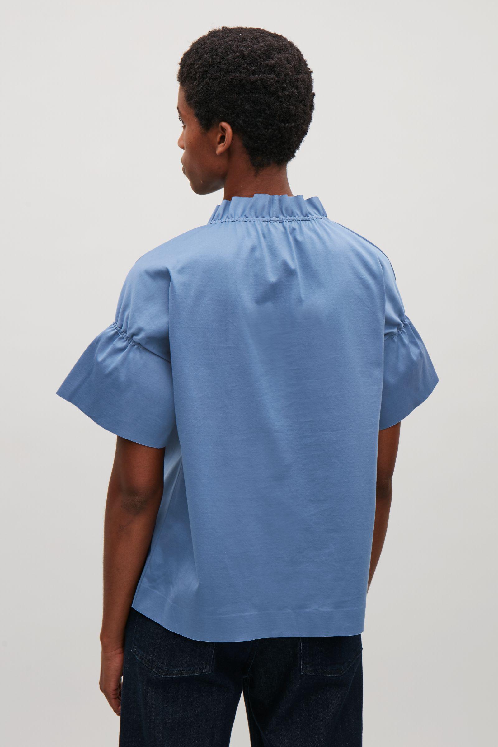 light blue ruffle top