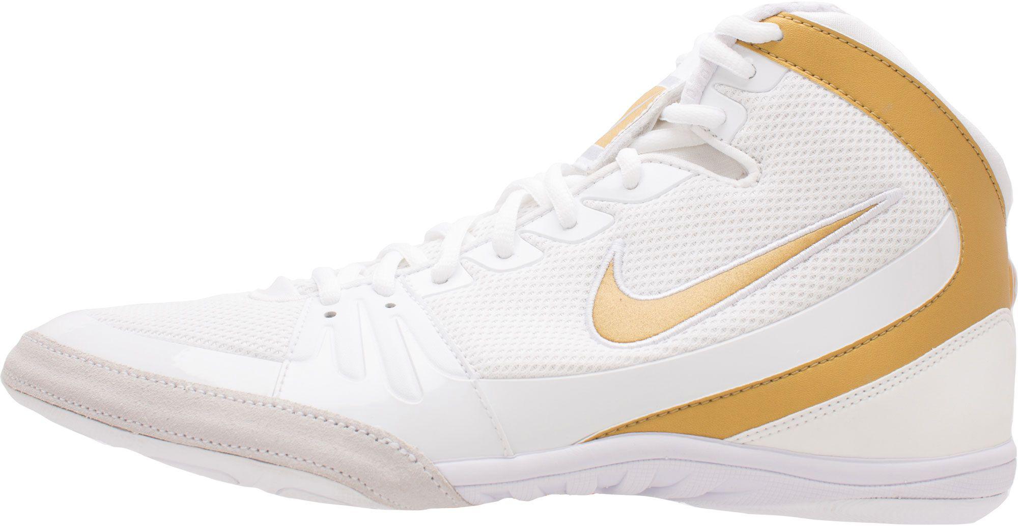 white and gold nike shoes