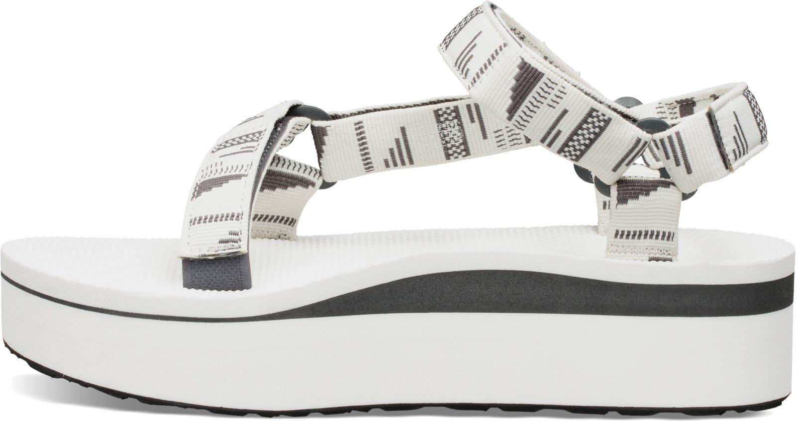 white teva flatforms